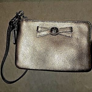 Coach NWOT metallic wristlet with a bow